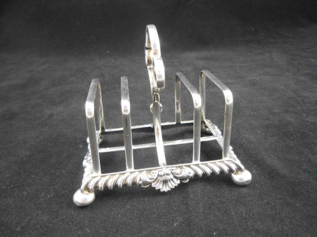 A James Dixon & Son silver toast rack with cast shell design, Sheffield 1899, W11.5cm - approx