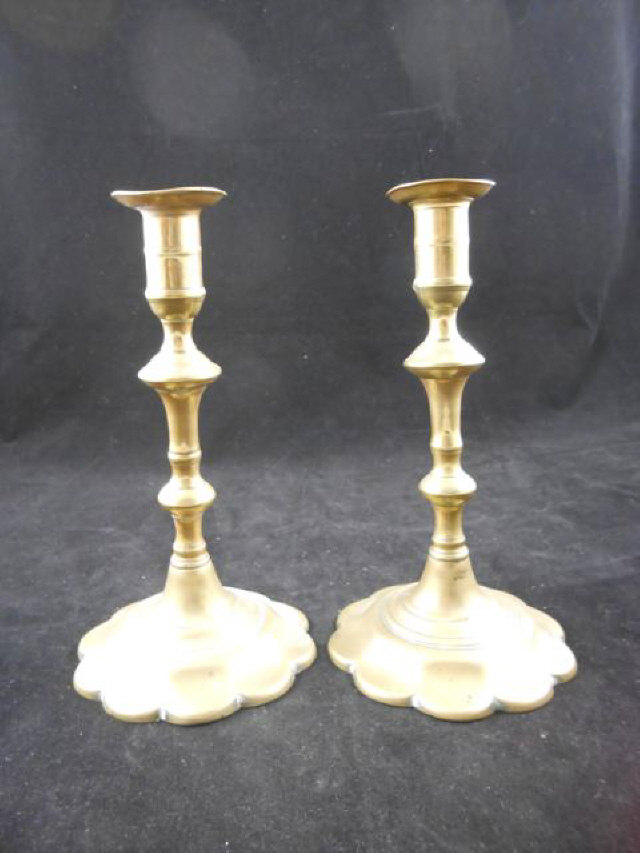 A pair of 18th century brass candlesticks with circular petal bases - H21cm