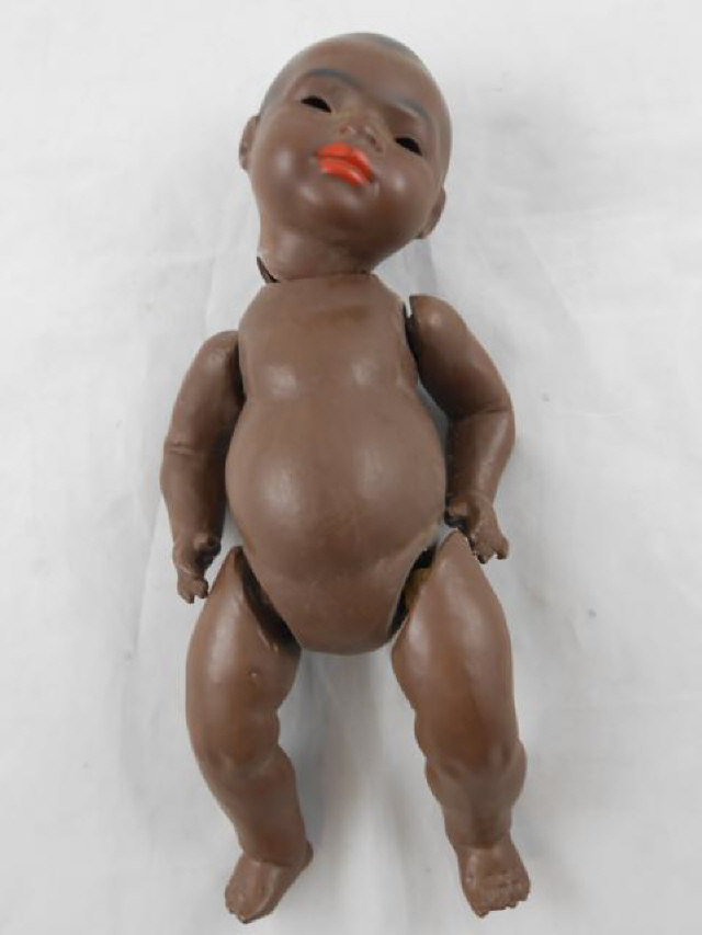 A Heubach Koppelsdorf bisque head and composition bent limb body black doll, pierced ears, eyes