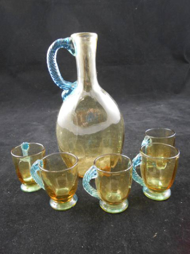 A 19th century Venetian style amber glass liqueur set with blue spiral glass handles, comprising