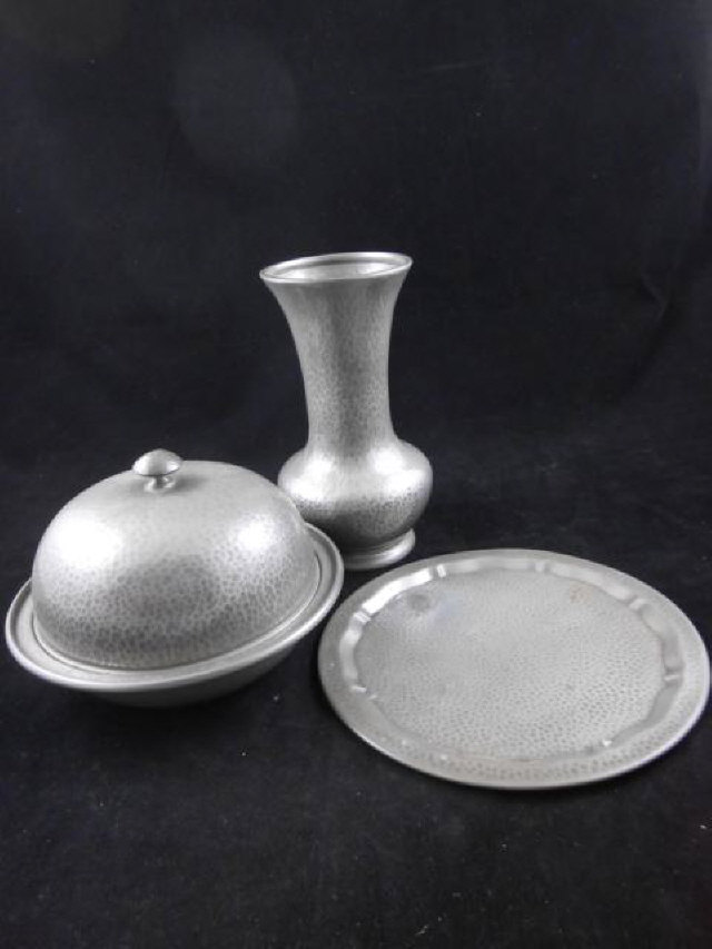 A Tudric pewter muffin dish and cover, no.01449, a Tudric pewter baluster vase, no.01414, together