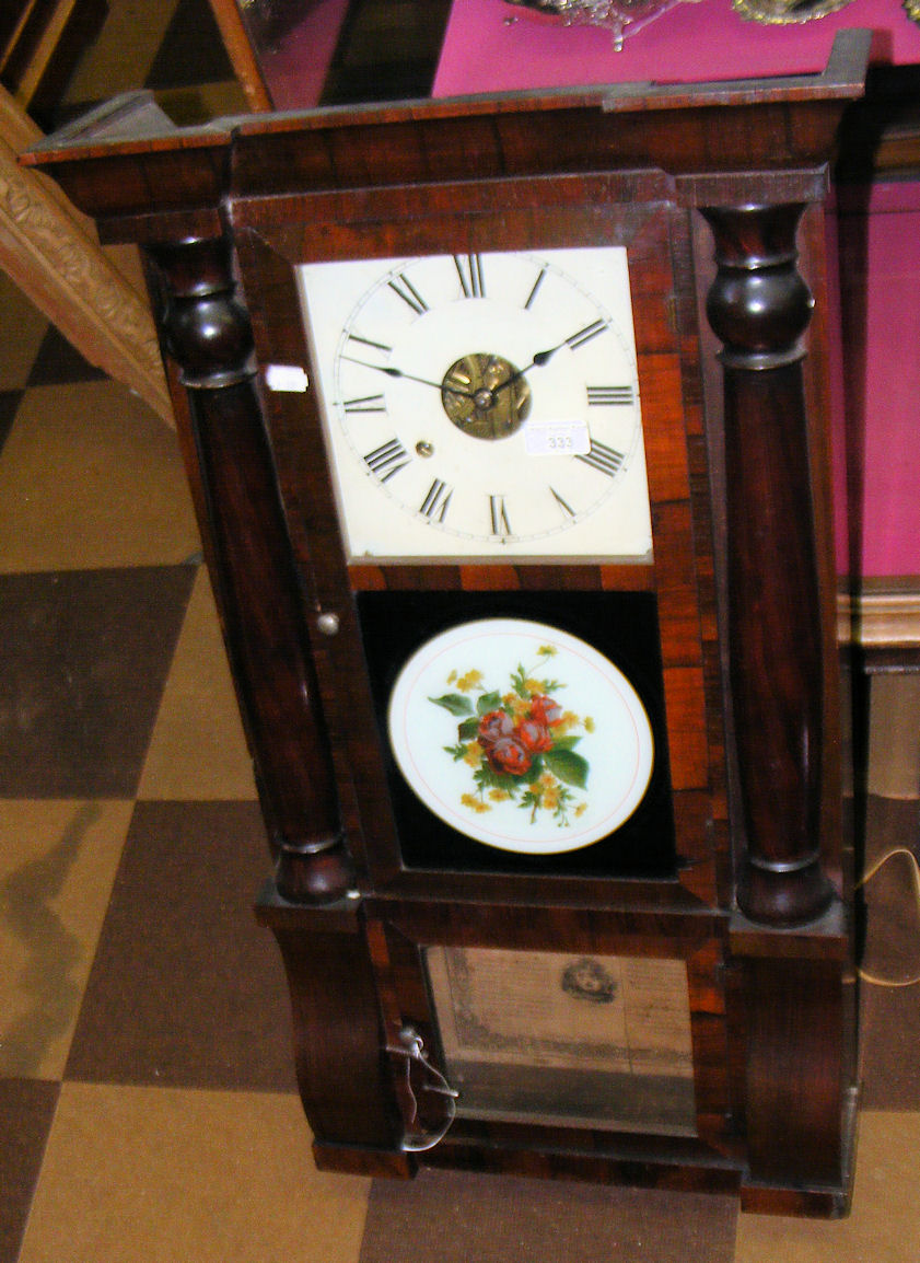 A Seth Thomas eight-day striking wall clock in rosewood case