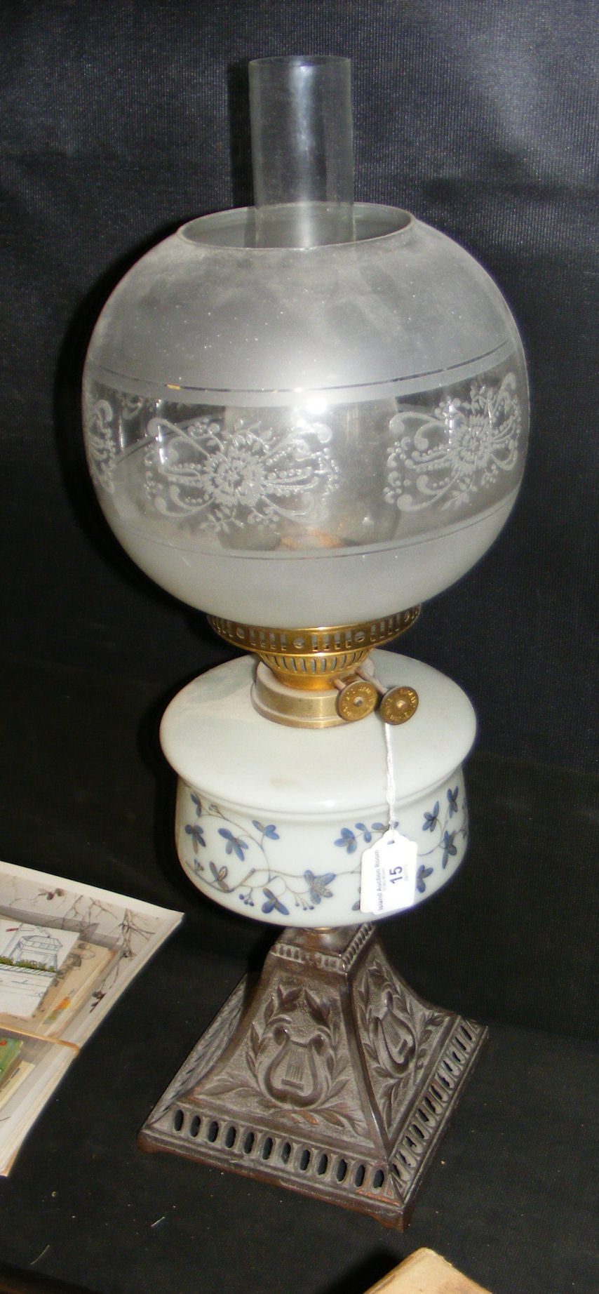 A Victorian oil lamp with etched glass shade