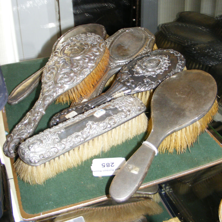 A collection of six assorted silver backed hair and clothes brushes