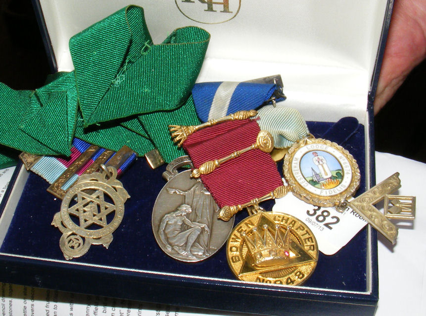 A collection of five assorted silver gilt and other Masonic jewels