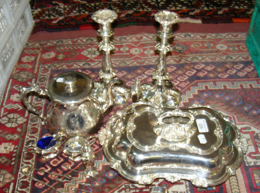 A quantity of plated ware including pair of embossed candlesticks, entree dish and cover,