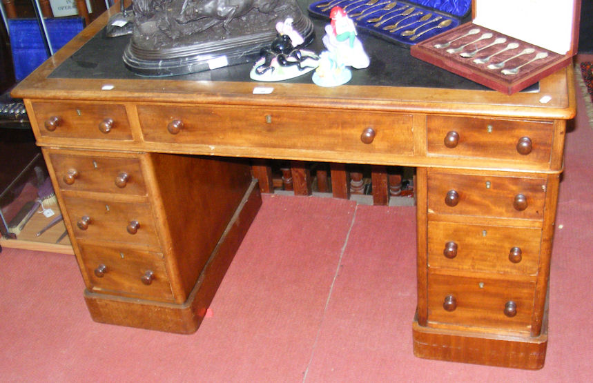 A Victorian pedestal desk with nine drawers to the front