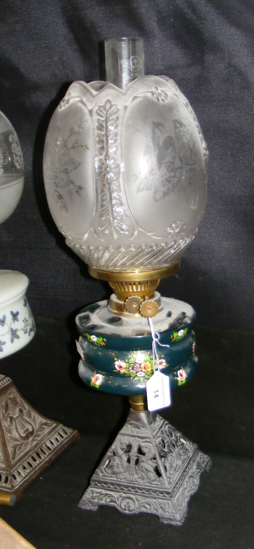 A Victorian oil lamp with etched glass shade