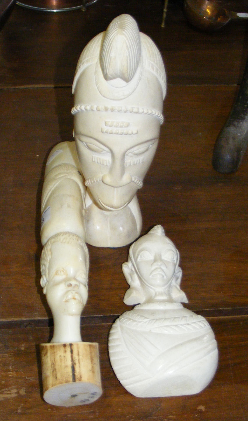 A carved ivory bust and two others