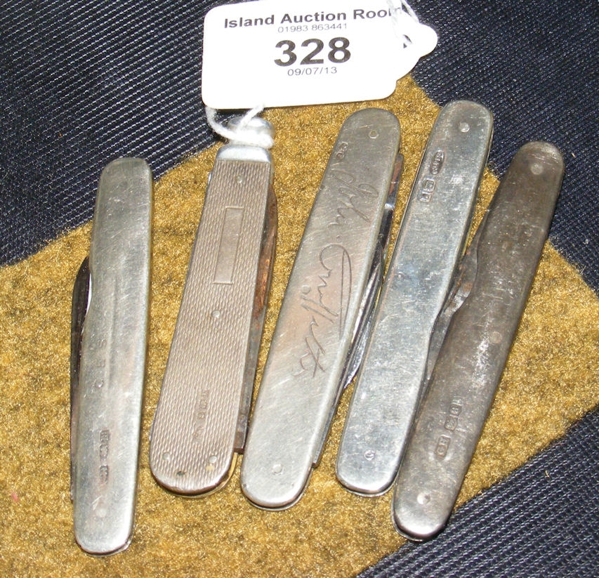 A collection of five assorted engine turned and other silver penknives