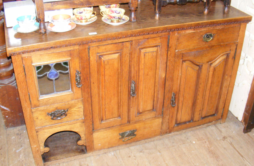 An Arts and Crafts style oak sideboard