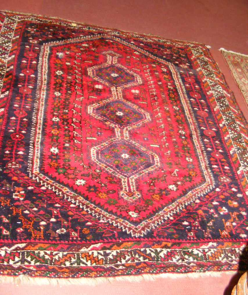 A Middle Eastern style rug with red ground