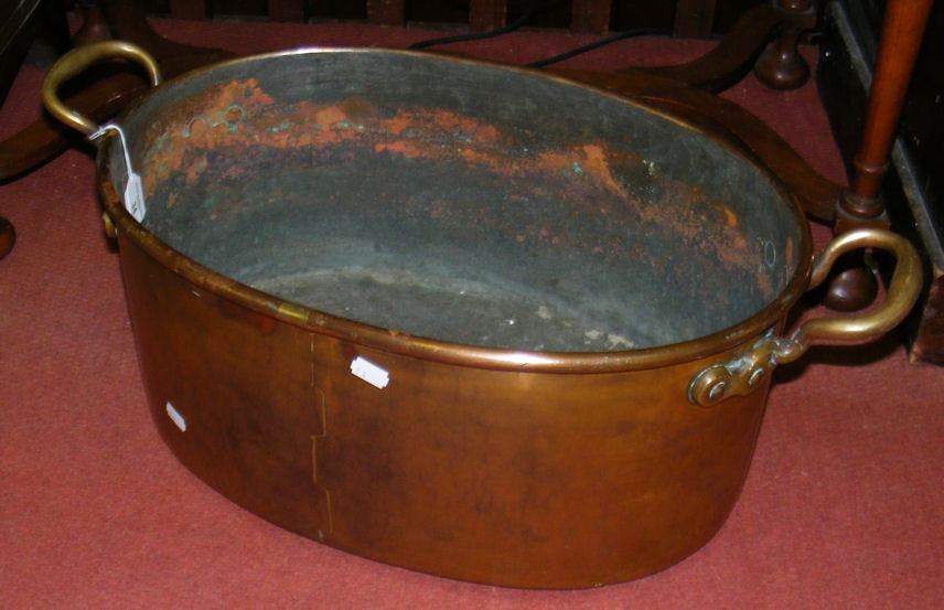 A 52cm two handled oval copper cauldron