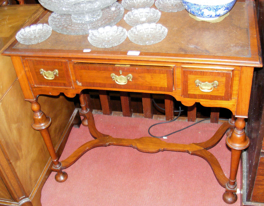 A Queen Anne style three drawer side table