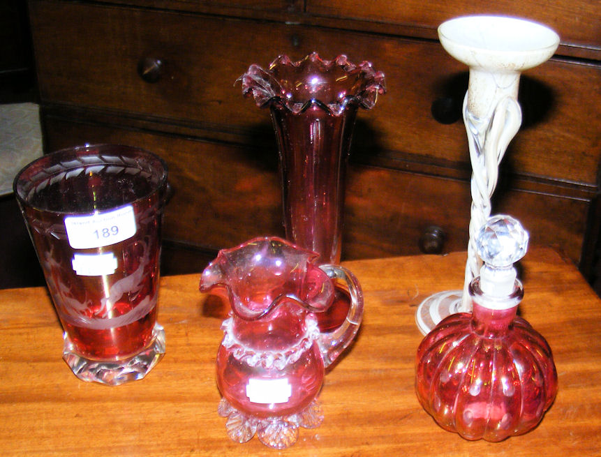 An engraved beaker, together with cranberry glass etc.