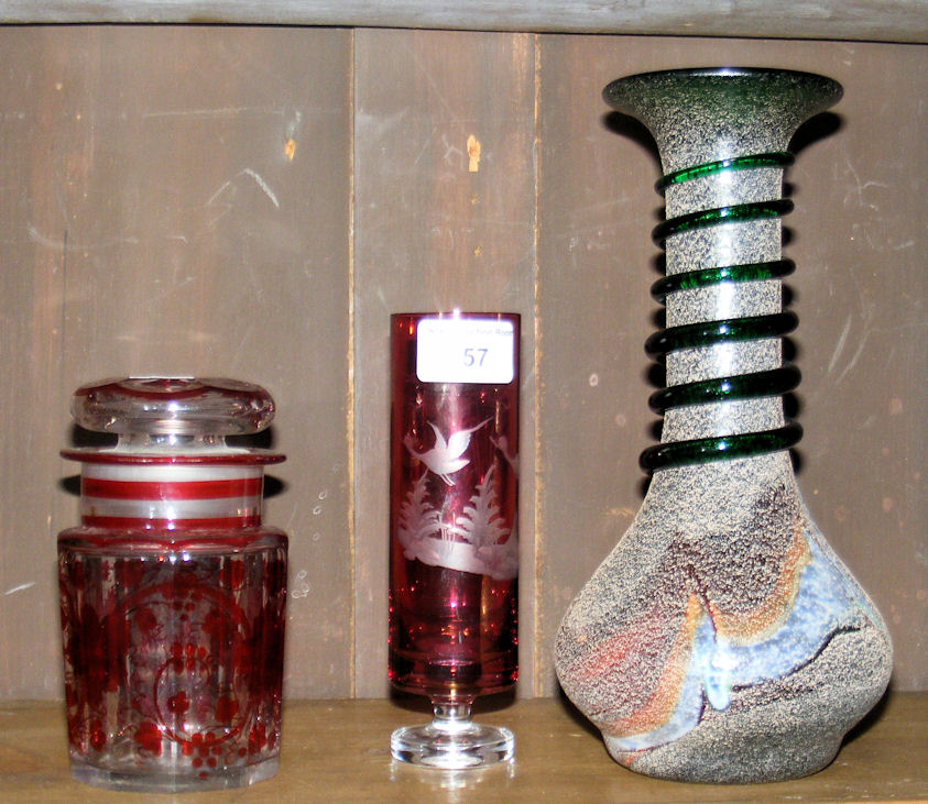 A red overlaid glass spill vase, an unusual studio glass vase and red over painted jar and cover