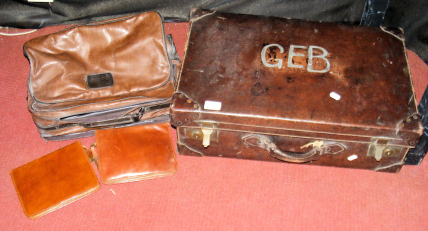 A leather suitcase, ditto holdall and two leather stationery cases