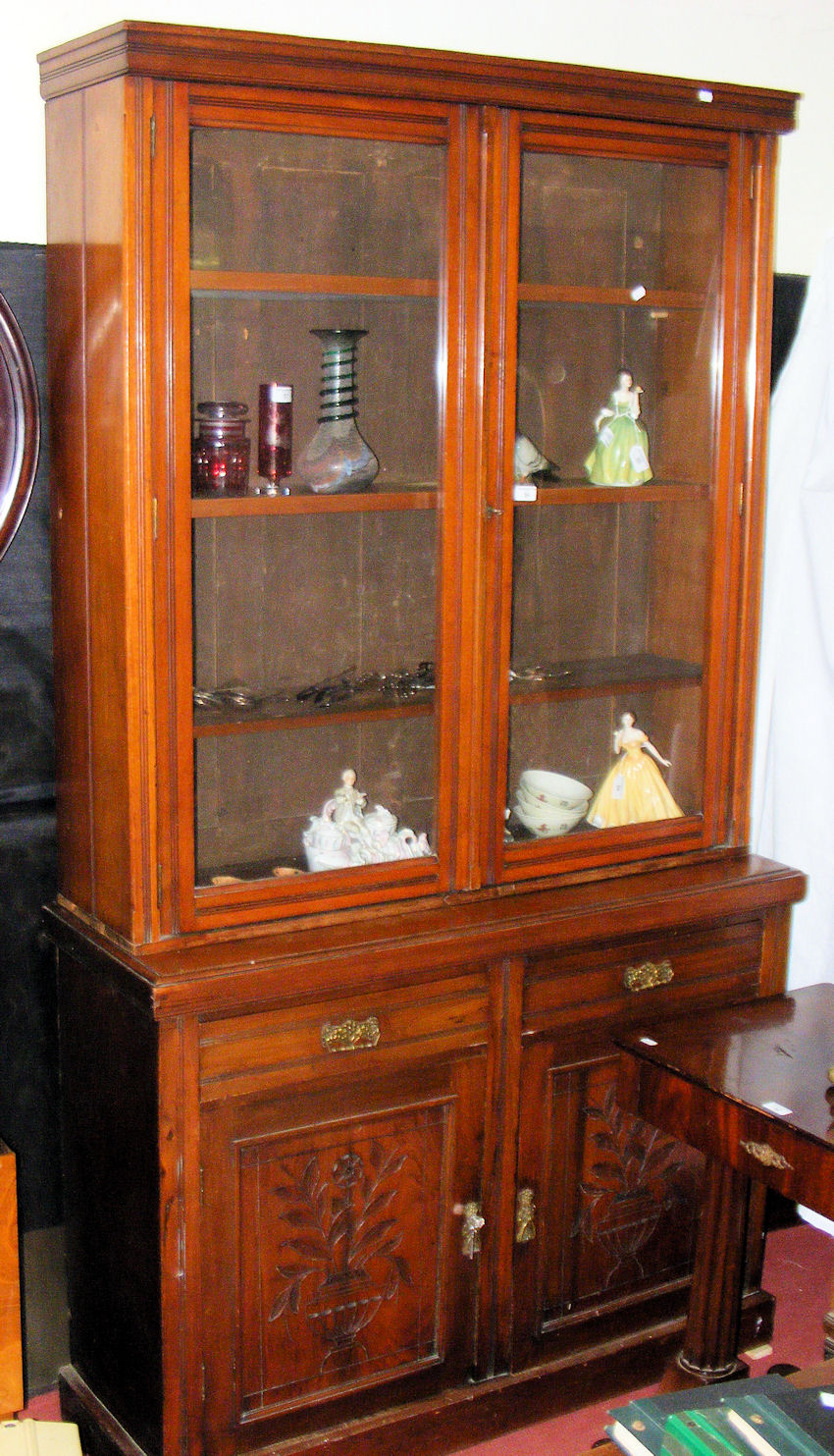 An Edwardian mahogany bookcase with three adjustable shelves enclosed by glazed doors to the top,