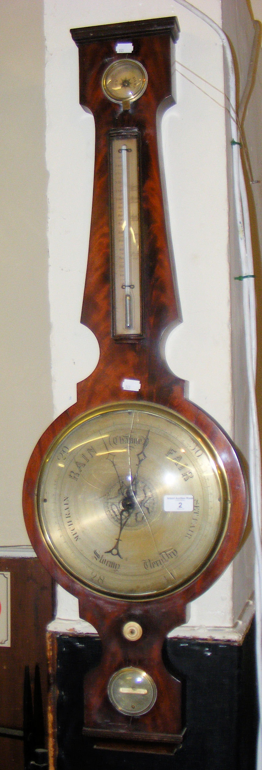 A mahogany cased banjo shaped mercurial barometer/thermometer