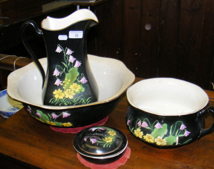 A four piece ceramic dressing table set