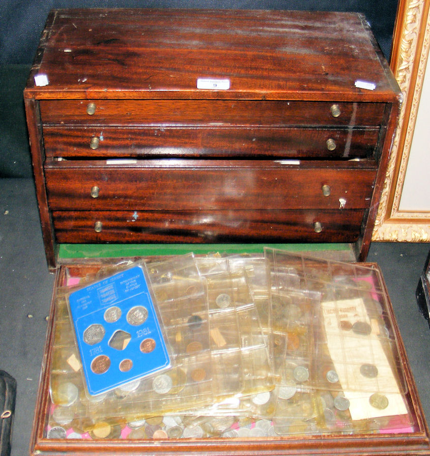 A four drawer mahogany collector’s cabinet, containing a vast quantity of assorted British and world