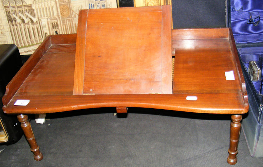 A Victorian mahogany bed table with hinged book rest