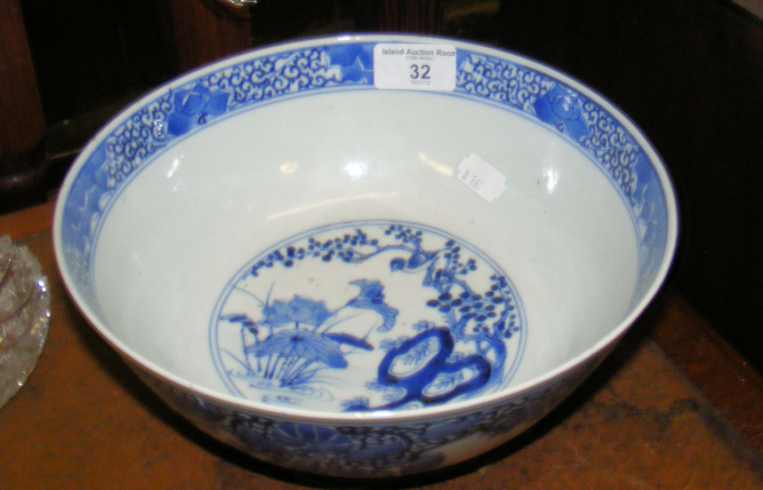 An antique Chinese blue and white bowl with four character signature to base - 23cm diameter