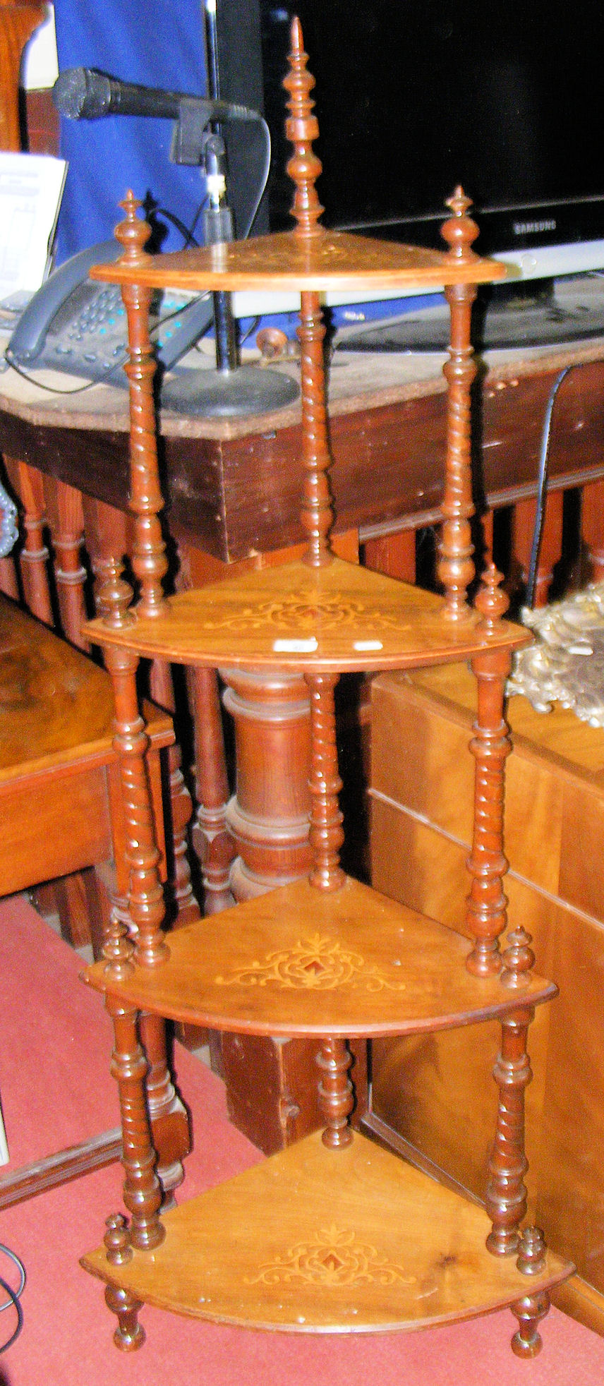 A Victorian inlaid walnut four tier corner whatnot