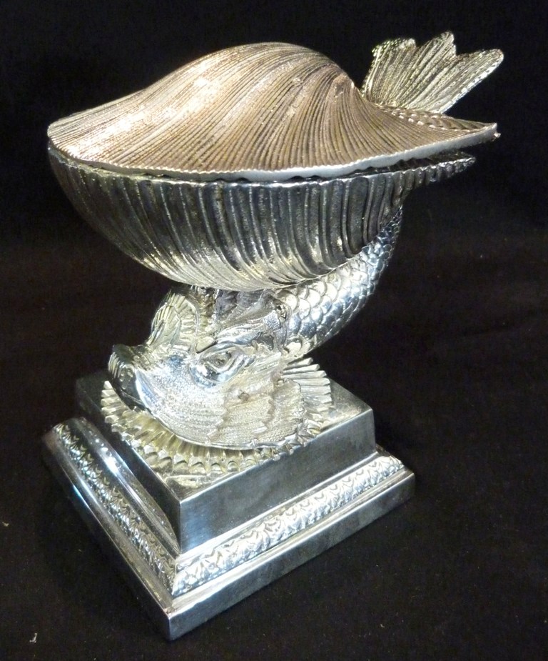 A Silver Plated Inkwell, in the form of a conch shell upon dolphin support with square stepped base