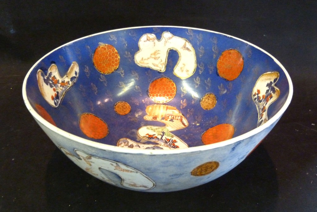 A 19th Century Chinese Porcelain Bowl, decorated with reserves upon a powder blue ground, 30cms