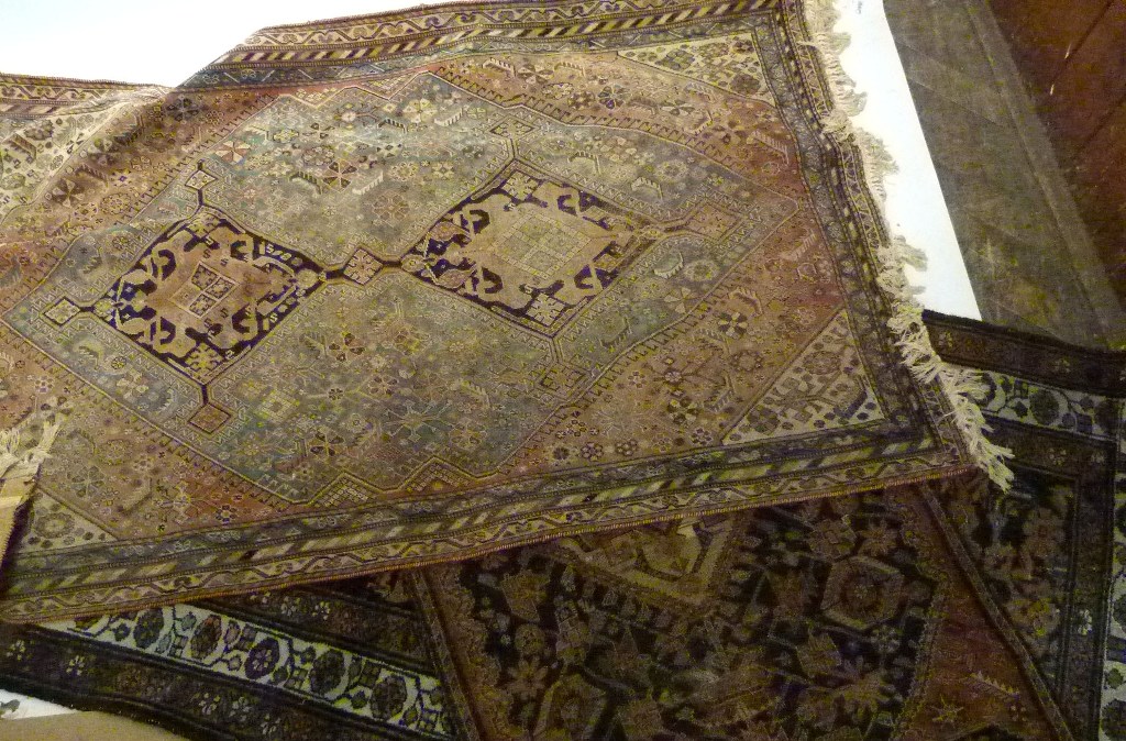 A North West Persian Rug, with an allover design with terracotta and blue ground within multiple