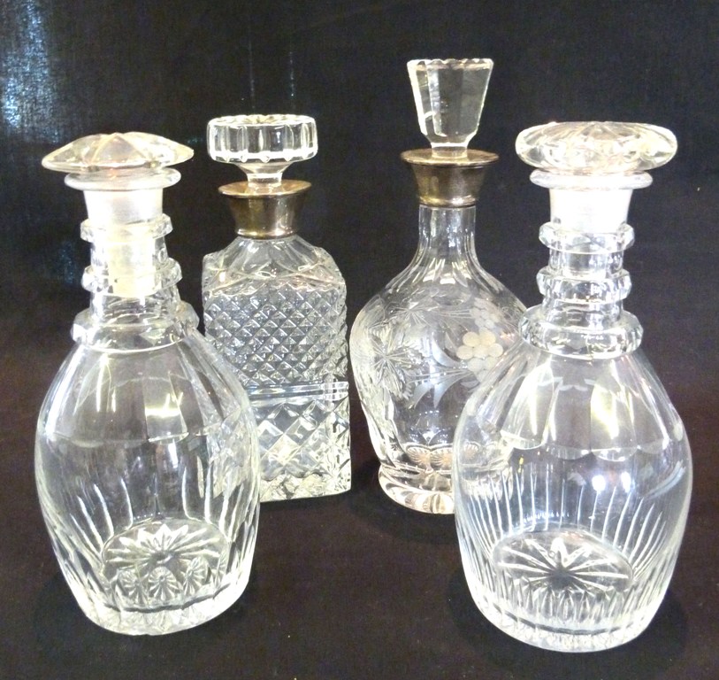 A Cut Glass Decanter, with silver collar, together with another similar and two other cut glass