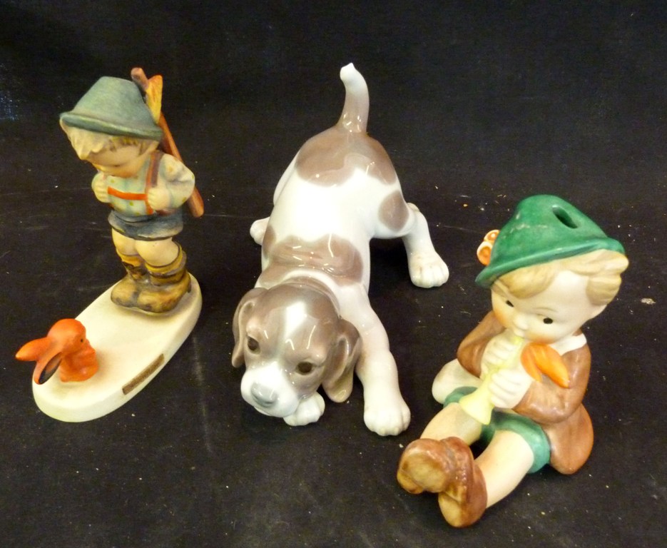 A Lladro Model, in the form of a puppy, together with a Goebel Hummel figure and another similar