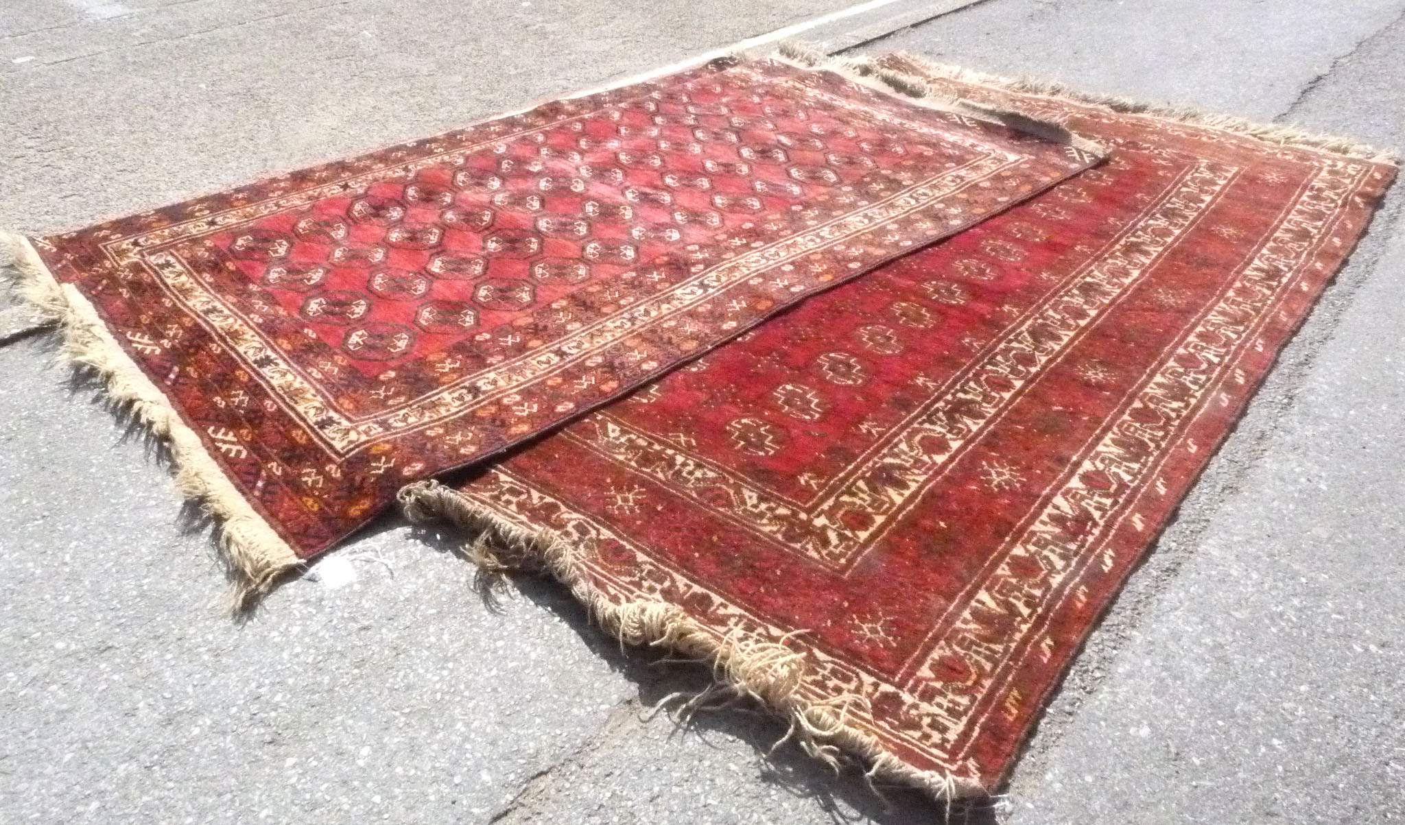 A Pair of North West Persian Style Woollen Rugs, with allover design upon a red ground within