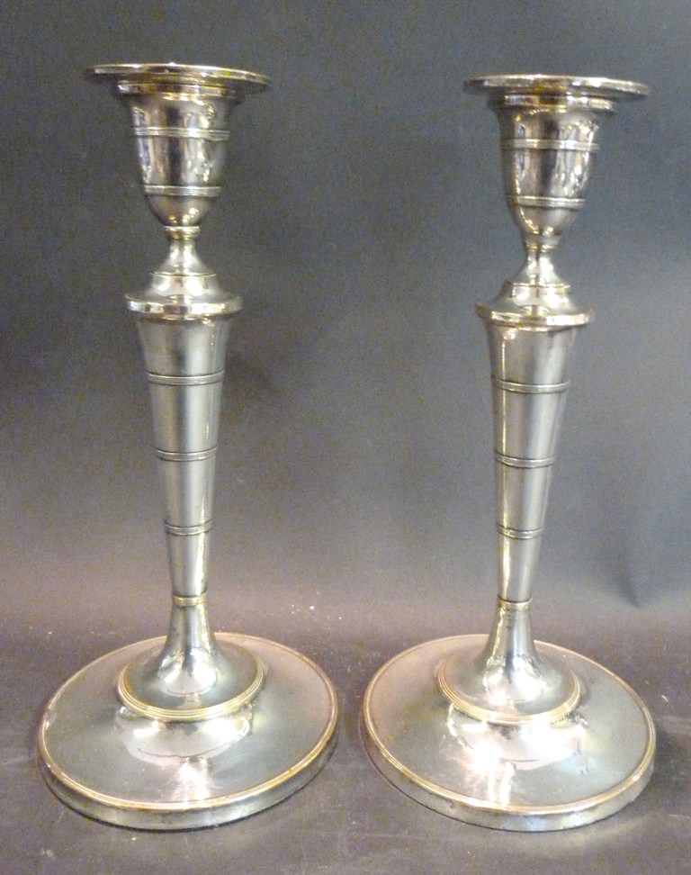 A Pair of Silver Plated Candlesticks, with circular bases, 27cms high