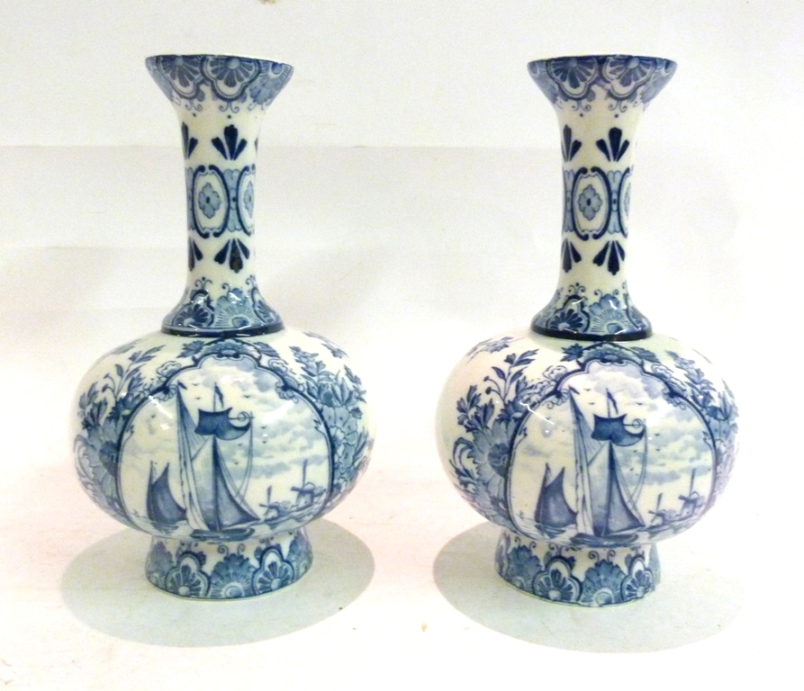 A Pair of Delft Underglaze Blue Decorated Bottleneck Vases, each decorated with reserves depicting