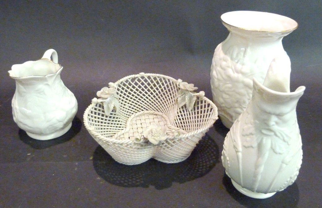 A Belleek Basket of Shaped Form, together with two Belleek jugs and a similar Belleek vase