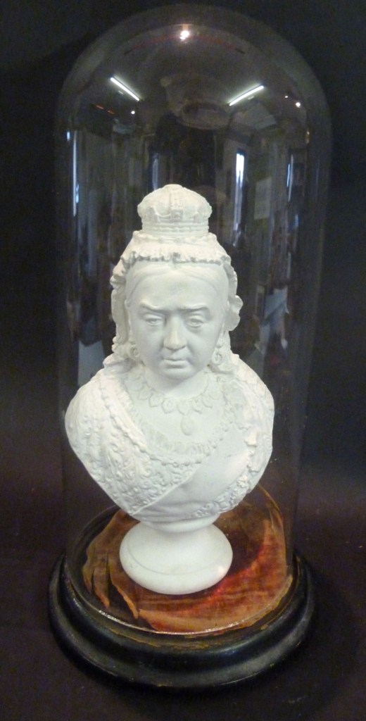 A Plaster Bust in The Form of Queen Victoria, under a glass dome with hardwood circular stand