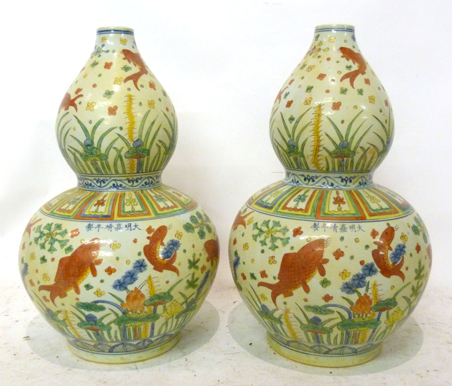 A Pair of Chinese Porcelain Large Gourd Shaped Vases, each decorated with fish amongst foliage in