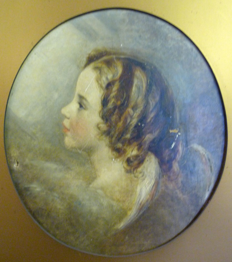 Early 19th Century English School SHOULDER LENGTH PORTRAIT OF CUPID Oil on canvas within an oval