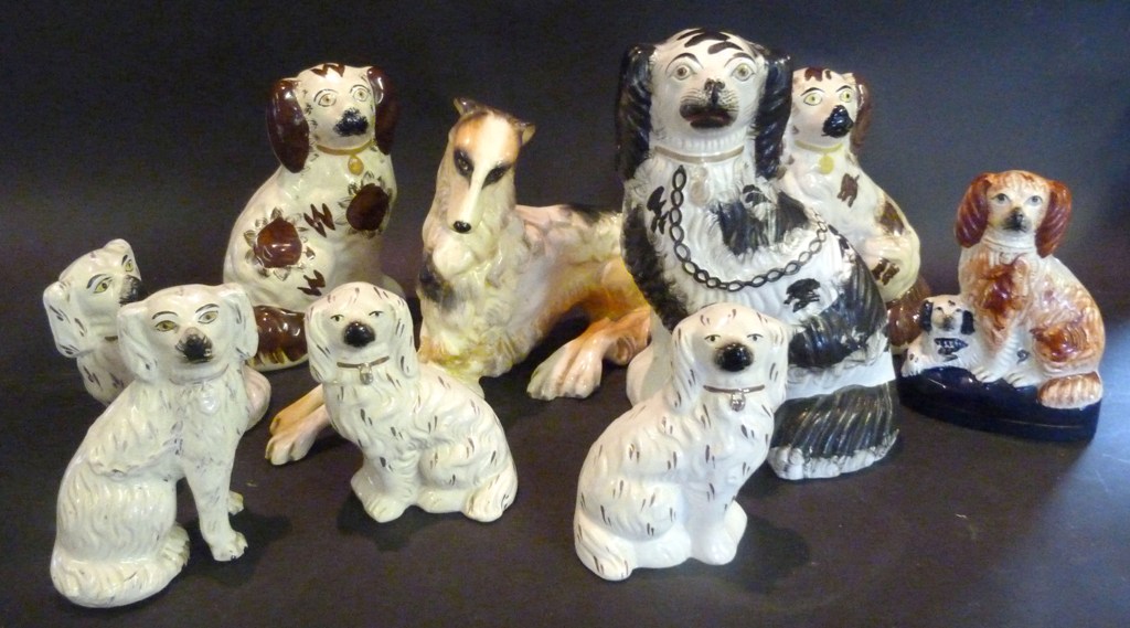 A Collection of Staffordshire Spaniels, and a similar model of a dog