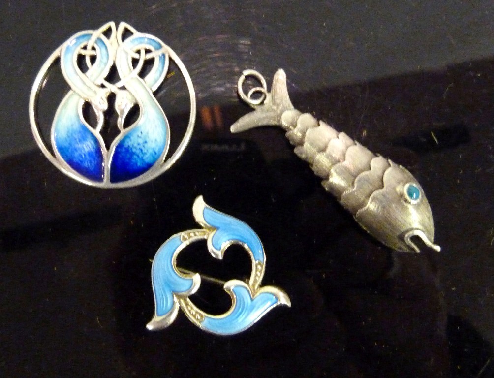 A Silver and Enamel Brooch, together with a pendant in the form of a fish and another pendant