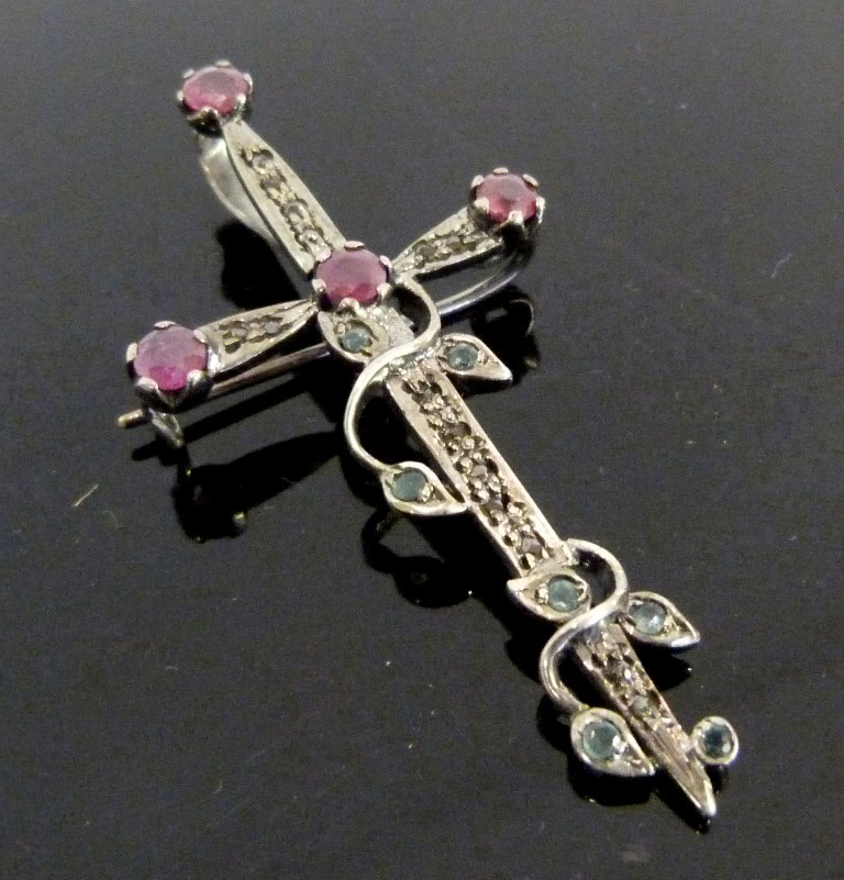 A White Metal Pendant Brooch, in the form of a sword encrusted with rubies, emeralds and diamonds