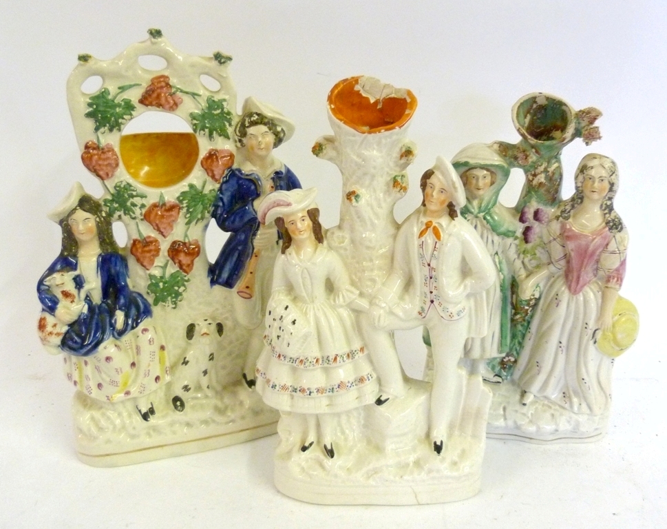 A 19th Century Staffordshire Group, with pocket watch compartment, together with two other similar