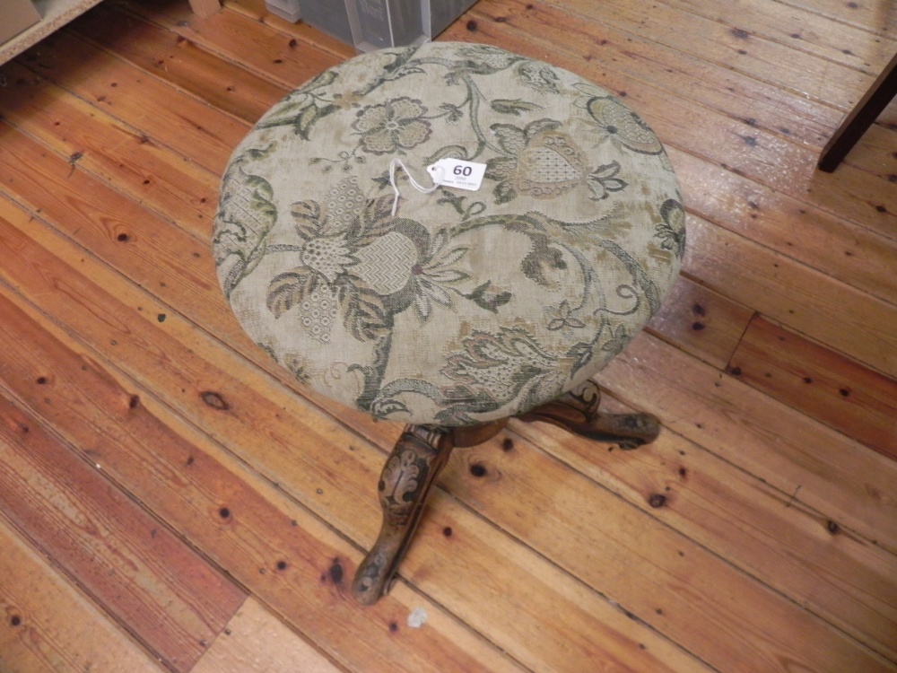 An antique covered Adjustable stool.