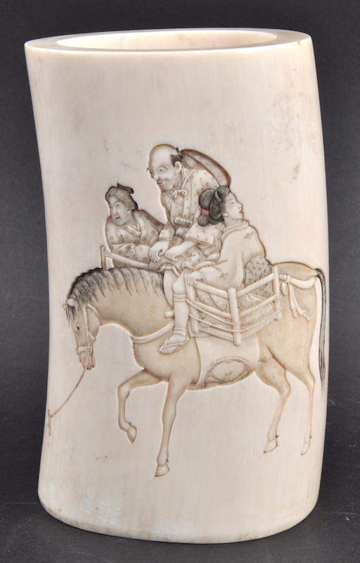 A 19TH CENTURY JAPANESE MEIJI PERIOD IVORY TUSK VASE carved with figures on board a horse