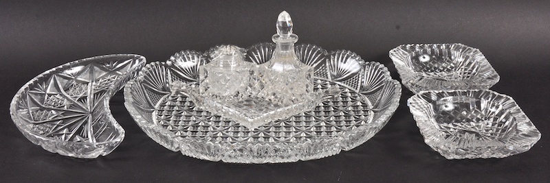 A CUT OVAL TRINKET TRAY, 12ins wide, two square ashtrays, a cruet, kidney dish.