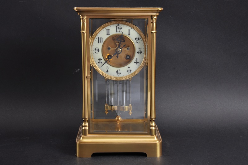 A LARGE 19TH CENTURY FRENCH BRASS FOUR GLASS CLOCK with mercury pendulum. 12ins high.