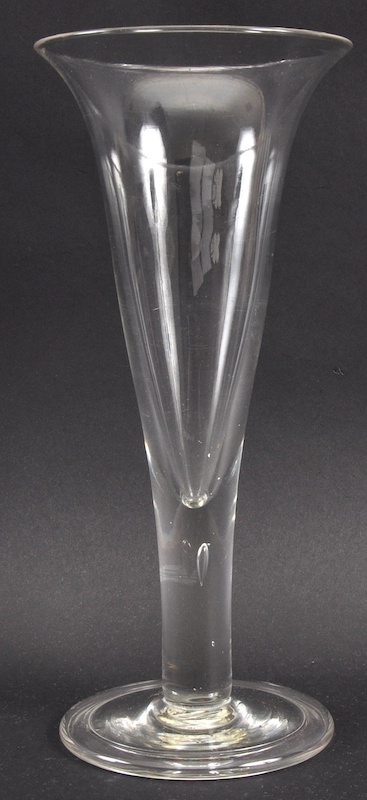 A LARGE PLAIN FLUTED GLASS with teardrop stem and circular base. 10.5ins high.