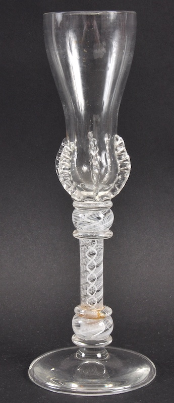 AN UNUSUAL GEORGIAN FLUTED TALL WINE GLASS with white opaque and knopped stem. 9ins high.